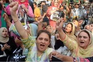Women activists of various political parties shout slogan in a protest rally in support of Armed Forces at Karachi Press Club