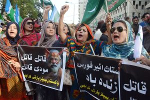 Women activists of various political parties shout slogan in a protest rally in support of Armed Forces at Karachi Press Club