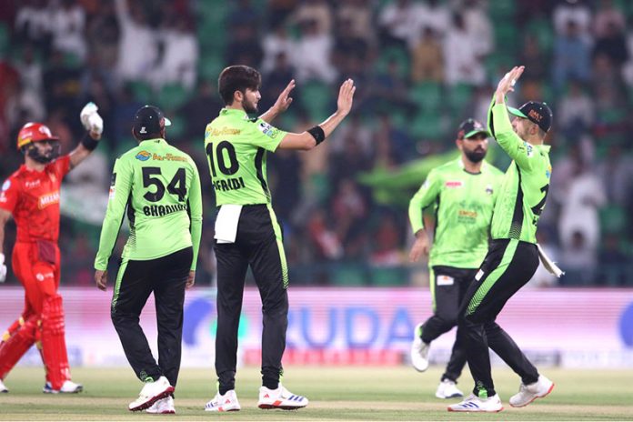 Lahore Qalanders players celebrate the wicket of Islamabad Uniteds’ Muhammad Shahzad bowled by Shaheen Shah Afridi during the Pakistan Super League PSL-X T20 cricket match between Lahore Qalanders and Islamabad United at the Gaddafi Cricket Stadium
