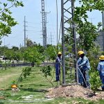 IESCO staffers busy installing new electric wires on electric poles at IJP Road in Federal Capital