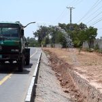 CDA worker busy in watering plants while sitting on the water tanker on green belts at Club road