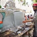A vendor selling ice at his roadside stall as demand increased during hot weather in Federal Capital