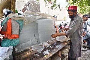 A vendor selling ice at his roadside stall as demand increased during hot weather in Federal Capital