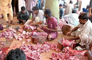 Butchers busy in making parts after slaughtering sacrificial animals in the city on the Second day of Eidul Azha.