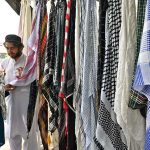 A vendor sells mufflers at his roadside setup in Aabpara, the Federal Capital