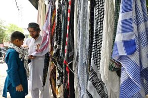 A vendor sells mufflers at his roadside setup in Aabpara, the Federal Capital
