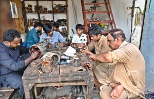 Mechanics are busy repairing and refurbishing burned-out motors in their shop on City Road.