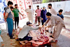 Butchers busy in making parts after slaughtering sacrificial animals in the city on the Second day of Eidul Azha.