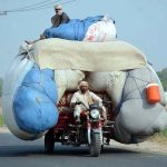An overloaded motorcycle rickshaw on the way violating the traffic rules and creating hurdles for smooth traffic flow