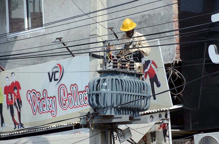 WAPDA staffer busy in repairing power transformer