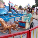 Visitors enjoy swing on merry-go round on 3rd day of Eid Ul Azha celebrations at River Chenab Park
