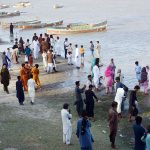 Families enjoy a refreshing break by the Indus River to beat the heat on a hot summer day