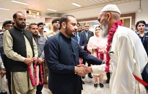 Provincial Health Minister Khawaja Imran Nazir welcomes the pilgrims of the first Hajj flight at the airport