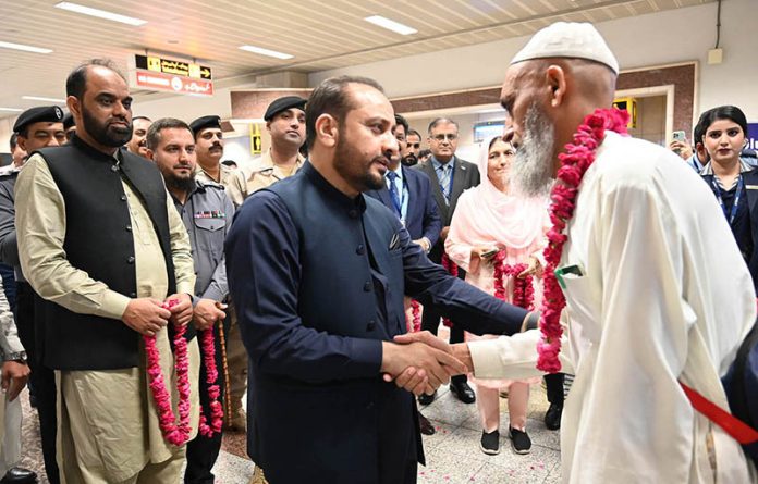 Provincial Health Minister Khawaja Imran Nazir welcomes the pilgrims of the first Hajj flight at the airport