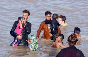 Families enjoy a refreshing break by the Indus River to beat the heat on a hot summer day