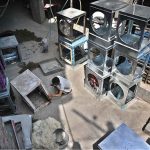 A worker busy in repairing room cooler at his workplace in Federal Capital