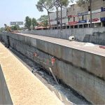A labourer busy giving finishing touches to the wall at the under-construction underpass site in Saddar Cantt in twin cities