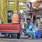 A man enjoys a glass of sugarcane juice to quench his thirst and beat the scorching heat in the federal capital