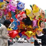 Two vendors displaying different shapes balloons to attract the customers at Karachi Company