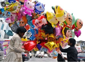Two vendors displaying different shapes balloons to attract the customers at Karachi Company