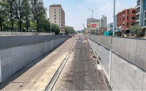 A labourer busy giving finishing touches to the wall at the under-construction underpass site in Saddar Cantt in twin cities