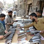 A vendor displaying knives and another items at Fort Road to be used for slaughtering sacrificial animals on the occasion of Eid-ul-Adha