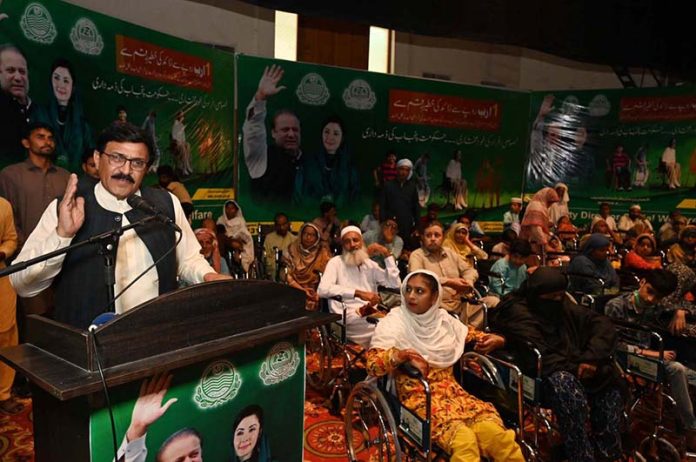 Chairman Sargodha Waste Management Company, Chaudhary Abdul Razzaq Dhillon, addresses a wheelchair distribution ceremony for differently-abled deserving persons at Sargodha Arts Council, organized by the Social Welfare Department and Baitul Mal