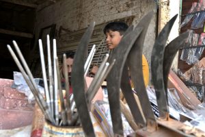 A vendor displaying knives and another items at Fort Road to be used for slaughtering sacrificial animals on the occasion of Eid-ul-Adha