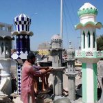 An artist busy in making minaret of mosque at a factory in the city