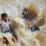 Youngsters beat the scorching heat by diving into a canal, turning the sweltering weather into a moment of joy and relief