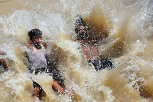 Youngsters beat the scorching heat by diving into a canal, turning the sweltering weather into a moment of joy and relief