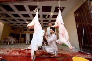 Butchers busy slaughtering sacrificial animals on the 2nd day of Eid ul Azha.