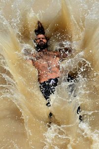 Youngsters beat the scorching heat by diving into a canal, turning the sweltering weather into a moment of joy and relief