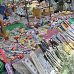 A young vendor displays sports items at his roadside setup to attract passersby in the federal capital