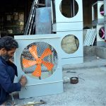 A worker busy in preparing room cooler at his workplace
