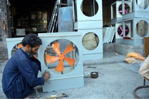 A worker busy in preparing room cooler at his workplace