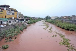 A view of water level increased in Nullah Lai due to early morning heavy rain in the city.