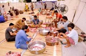 People slaughtering sacrificial animals as the religious ritual on the 2nd day of Eid ul Azha.