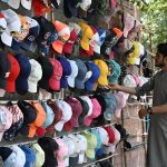 A youngster is selling second hand caps as per increased demand during scorching heat wave experienced in the city.