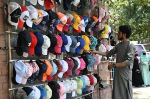 A youngster is selling second hand caps as per increased demand during scorching heat wave experienced in the city.