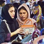 Women busy in selecting and purchasing hand bags from stall for preparation of upcoming Eid-ul-Adha in a local market