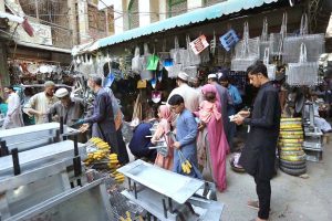 Blacksmith busy sharpening knives to be used for slaughtering sacrificial animals in connection with Eidul Azha