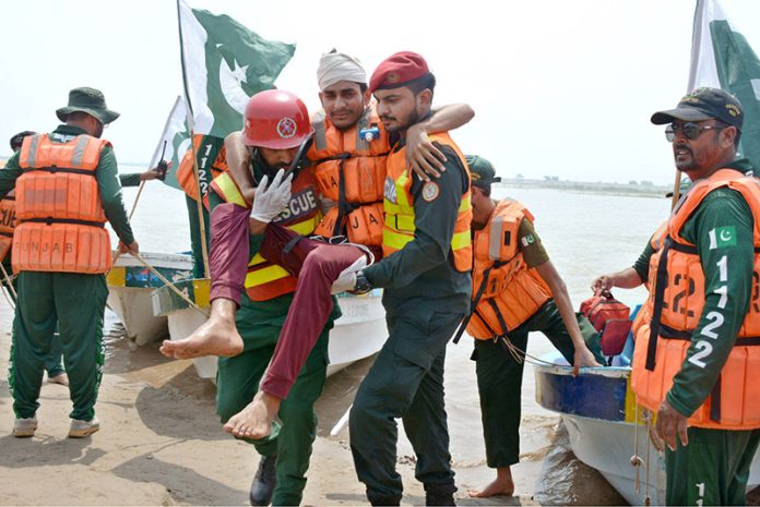 Rescue 1122 personnel perform life-saving drills during a pre flood mock exercise in Chenab River