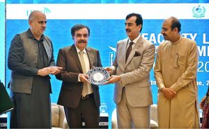 Chairman Senate of Pakistan, Syed Yousuf Raza Gillani, presents a shield to Governor of Balochistan Sheikh Jaffar Khan Mandokhail during the seminar on "Faculty Leadership & Management Excellence (FLAME) 2025", organized by the Higher Education Commission (HEC) at a local hotel