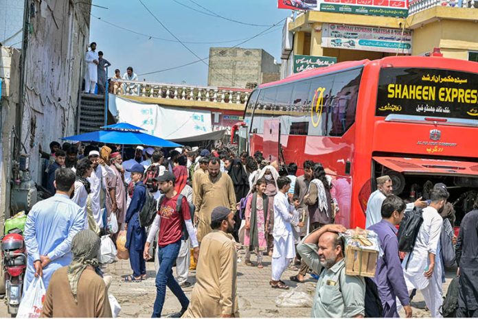 A large number of people arrive at Pirwadai Bus Stand to depart for their hometowns to celebrate upcoming Eidul Azha with their families