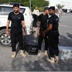Police commandos from Pakistan’s Federal Board of Revenue (FBR) shift boxes with copies of the 2025–26 fiscal budget outside the Parliament House, before the start of the budget session
