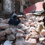Workers select and sort pink salt at his workplace to ensure high quality for export