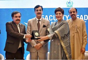 Chairman Senate of Pakistan, Syed Yousuf Raza Gillani, presents a shield to Governor of Balochistan Sheikh Jaffar Khan Mandokhail during the seminar on "Faculty Leadership & Management Excellence (FLAME) 2025", organized by the Higher Education Commission (HEC) at a local hotel