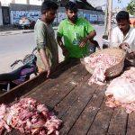A vendor purchases beef tallow (fat) from people on the third day of Eidul Adha at Korangi