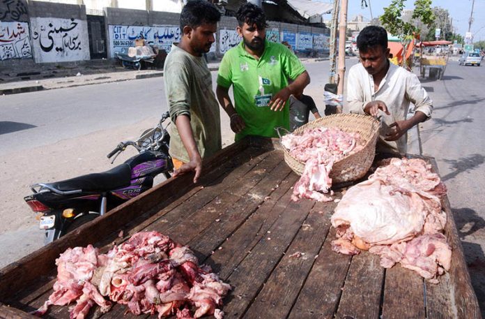 A vendor purchases beef tallow (fat) from people on the third day of Eidul Adha at Korangi